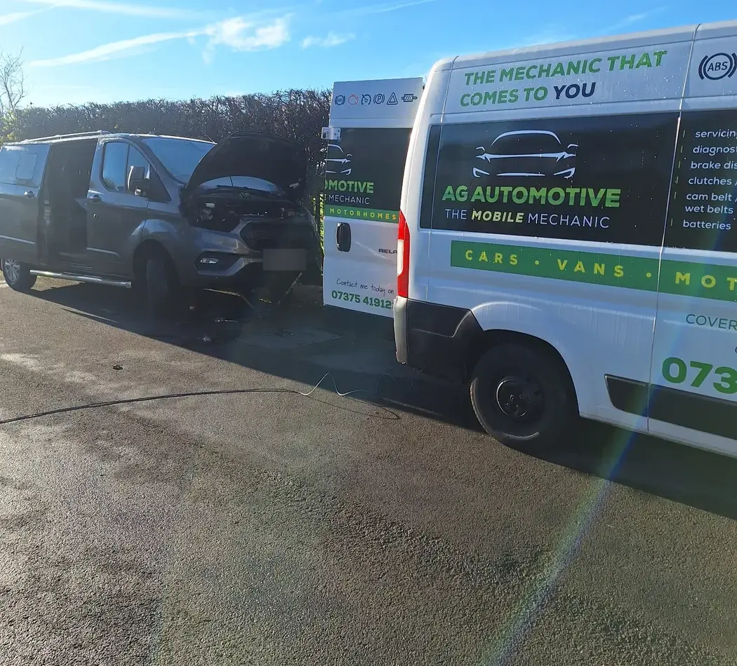 The AG Automotive van parked beside a grey Transit Custom with its bonnet up